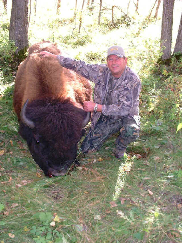 John Carr from Louisiana with trophy bison at Echo Lake Hunts in Saskatchewan