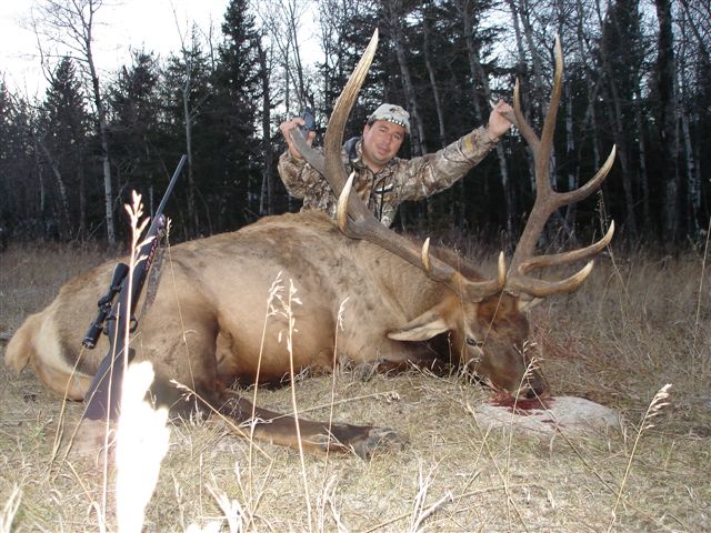 Julio Gomez Jr from Mexico with trophy bull elk at Echo Lake Hunts in Saskatchewan