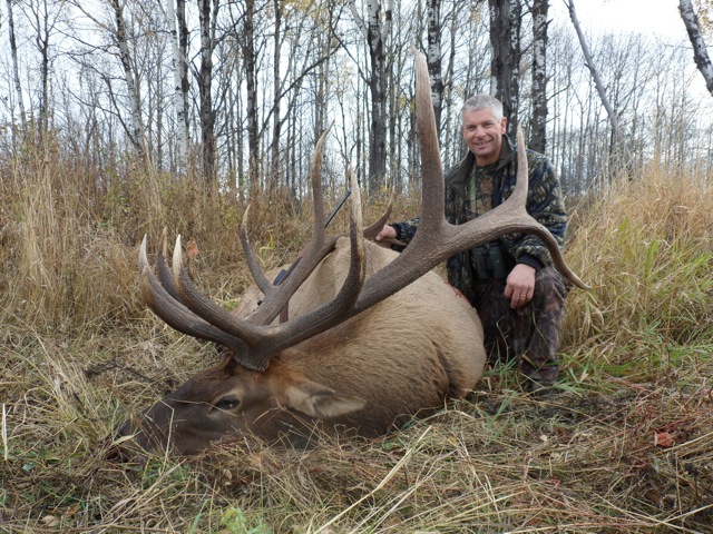 Cal Gilbertson from Canada with trophy bull elk at Echo Lake Hunts in Saskatchewan